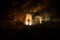 Old stone house burning uncontrollable in the night. A fire in a country house. Creative artwork decoration