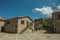 Old stone house on cobblestone alley and castle wall