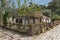 Old stone house and violet flowers in village of Aliki, Thassos island, Greece