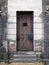 Old stone jail wooden door with iron bars