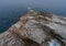 Old stone lighthouse on rocky island Scoglietto.