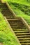 Old stone mossy staircase in lush green grass