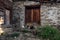 Old stone rural building in Svaneti Georgia with wooden door and chickens