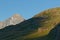 Old stone shelter on the green slopes of French Alps