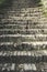 Old stone staircase made of small bricks. Beautiful details and greenery around every step. Walking and hiking theme