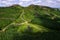 Old stone tower and foot path to Devils bit hill in county Tipperary, Ireland. Irish nature landscape with green fields and forest