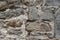 An old stone wall brown large stones. Classical masonry walls of medieval castles in Europe.