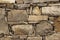 An old stone wall brown large stones. Classical masonry walls of medieval castles in Europe.