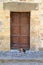 Old stone wall and door with cats in Greece