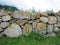 An old stone wall in the fog in the mountains