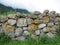 An old stone wall in foggy mountains made of large cobblestones