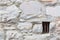 Old Stone Wall With Small Iron Barred Prison Cell Window