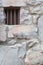 Old Stone Wall With Small Iron Barred Prison Cell Window