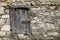 Old stone wall with wooden padlocked door