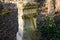 Old stone walls and walls in the old desolate cemetery with stone tombstones with detailed weathered reliefs. cast iron broken rus