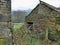 Old stone weathered barns and rusty gate.