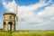 An old stone windmill in field