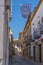 Old stoned alley in Baeza city, with a view to a tower