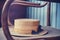 Old straw hat on vintage shabby chair, close-up