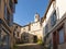Old street and clock door, in the medieval village of Cordes sur Ciel in autumn, in the Tarn, Occitanie, France