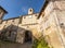 Old street and clock door, in the medieval village of Cordes sur Ciel in autumn, in the Tarn, Occitanie, France