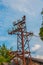 Old street concrete pillar with rusty iron part at top and cut wires. Installation or dismantling of electricity. Broken energy