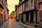 Old street in Honfleur, France with light of the rising sun