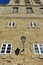 Old street light in stone wall with white windows close to Cathedral. Town Hall, Santiago de Compostela, Spain. Sunny day.