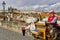 Old Street performer man offers music from a Large hand cranked music box, Charles Bridge, Prague, Czech Republic