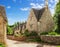 Old street with traditional Cotswold cottages in a sunny spring morning, Bibury, Gloucestershire, England, UK