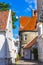 Old street with white wooden houses with tiled roofs