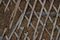 Old stucco walls with wooden mesh. Smeared with a coarse solution. Broken plaster on the wall with wooden battens and crumbling