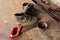 Old sturdy shoes, a strongly rusted saw and an ashtray - Stilllife of forgotten things