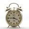 Old style alarm clock, metal, it`s quarter to four.