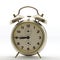 Old style alarm clock, metal, it`s quarter to nine.