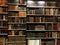 Old style book store with rows of books on a dusty shelf