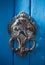An old style decorative bronze door handle on a wooden azure door, the distinctive feature and symbol of Malta in Mdina.