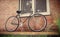 Old style singlespeed bicycle against brick wall