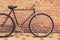 Old style singlespeed bicycle against brick wall