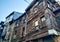 Old style tall wooden architecture building, weathered through years, with a rustic and vintage feeling to it