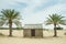 Old style village arabic small house in the desert between palm trees