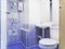 Old style washroom with small blue ceramic color decoration, toilet, washbasin and mirror