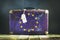 Old suitcase in the colors of the EU flag. Travels. Signs and symbols