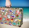 Old suitcase with stickers of flags of the of traveling