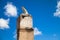 Old sundial under blue sky