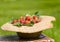 Old sunhat with strawberry in garden