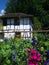 Old swiss farm house with flowers in garden in open-air museum ballenberg in switzerland