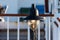 Old switched on metallic lantern on deck of ship with blurred railings in background