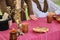 Old table with candelabra and people in ancient clothes. Top hat and old dishes-cups and mugs