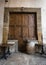 Old tables, wooden barrel and large wooden shutters on a marble wall in Arezzo, Italy